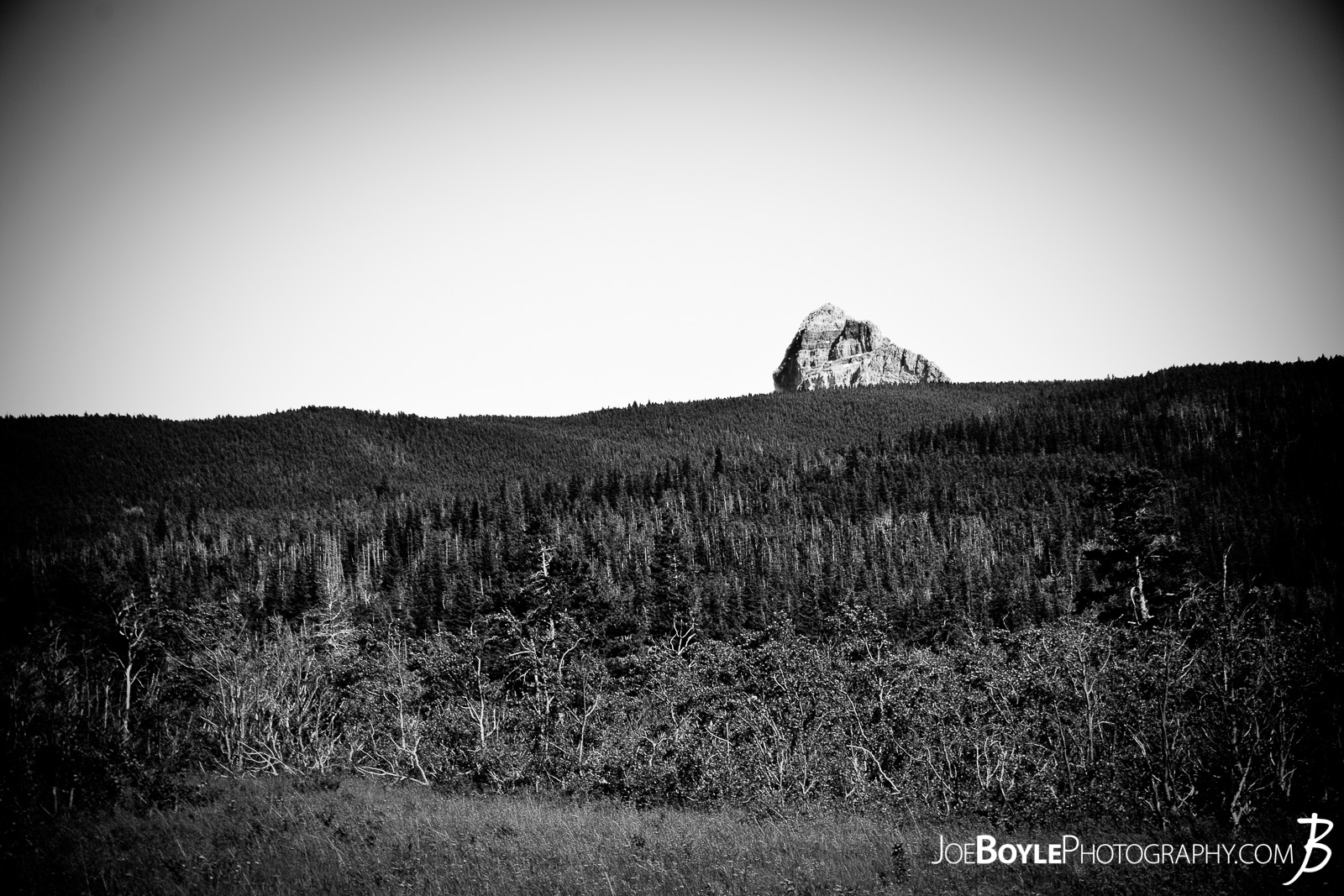  As I was hiking through Glacier National Park I stopped and looked up, (because I'm often staring at the ground making sure I don't step on a rock or twist my ankle), and I saw this iconic looking rock just sitting off in the distance. 