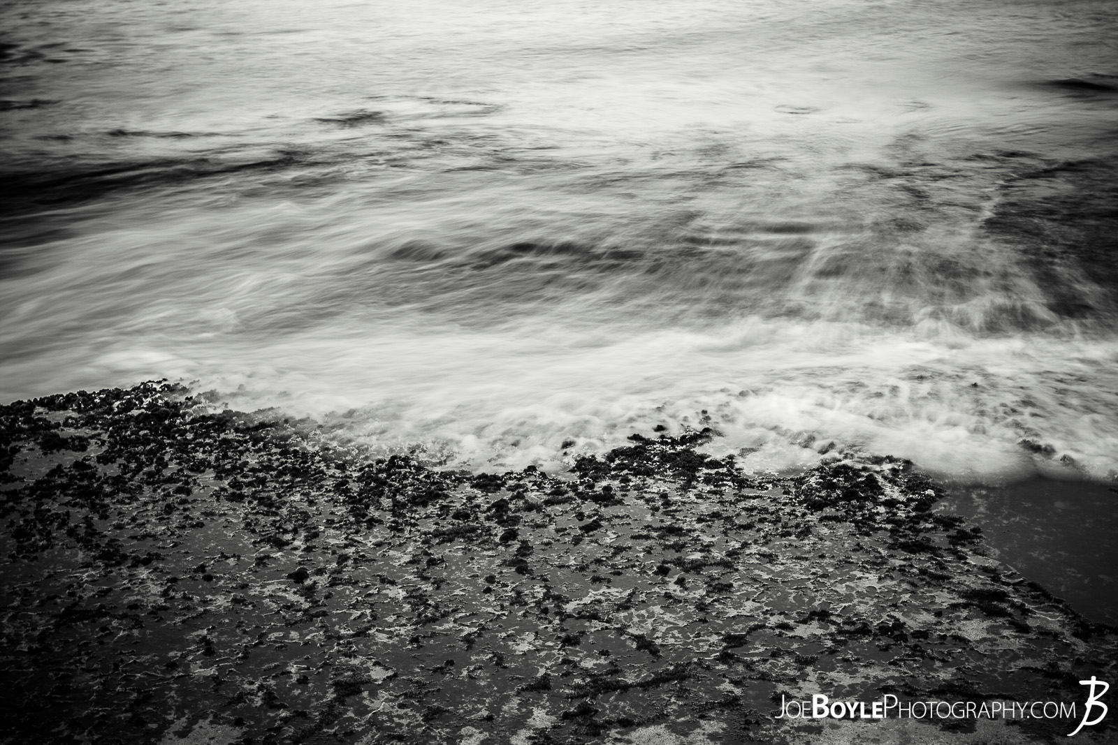  While I was in Hawaii, I naturally spent a bunch of time photographing the water as much as I could. This photo is of a receding wave. I left the shutter open just long enough to capture the "motion" of the wave. I really like how it turned out. 