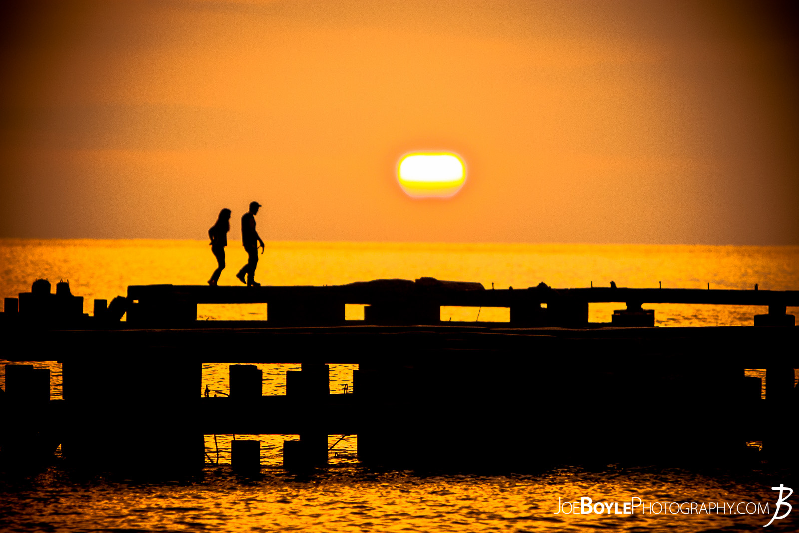  A beautiful sunset off the coast of Lake Erie with a pier in the foreground. This image was captured in Cleveland Ohio, specifically near Edgewater Park.  