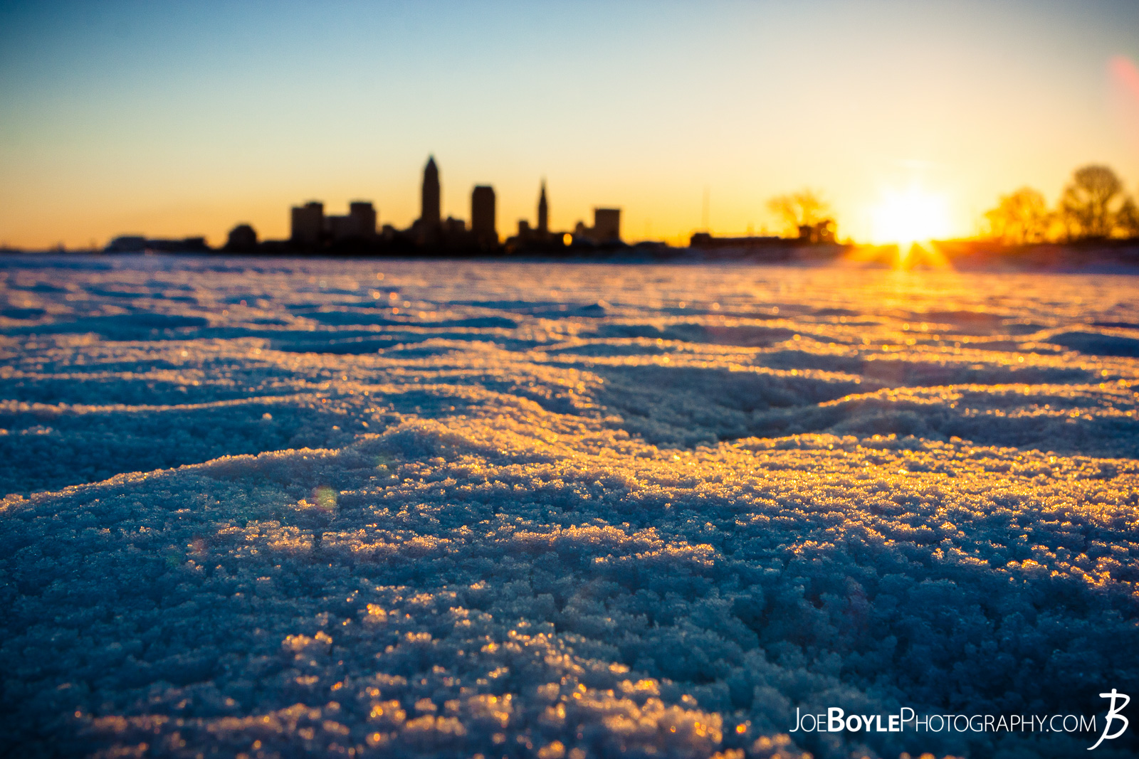  One chilly, wintery morning I was crazy enough, stupid enough or genius enough*?-?-?* to go out into the blustery cold and take this photo of the beautiful and magnificent sunrise over Cleveland, Ohio! To be honest, it actually wasn't that cold this particular morning. It was probably in the 40s. And it wasn't even that early. I think the sunrise was at 7:45am. That's early, but not, "crazy early." At least in my estimation. It was the 3rd day in a row where it was in the 40s and 50s so I was a little nervous about the ice breaking, but I'm here typing this so don't worry, I didn't die. Thank you for your concern. 