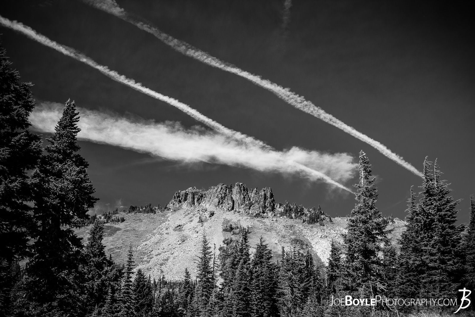  After we left Mowich Lake Campground, my buddy and I decided to take the Spray Park trail instead of the Wonderland Trail Proper. I read in Bette Filley's book, "Discovering The Wonders of the Wonderland Trail" that Spray Park offers some magnificent views whereas the Wonderland Trail is more forested and covered. The only catch is that if it's bad weather, Spray Park is absolutely miserable as there is no cover and it's the highest point on the trail. Thankfully we lucked out and had blue skies and great views! Here is a photo of Hessong Rock as seen from the Spray park Trail. You can view the color version at the following link: Hessong Rock In Spray Park 