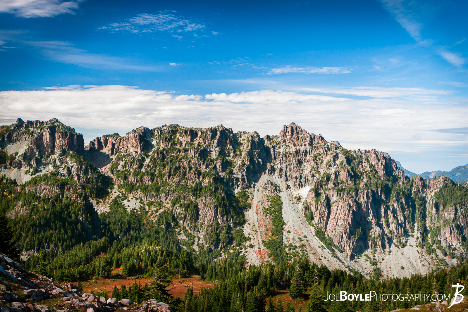  After we left Mowich Lake Campground, my buddy and I decided to take the Spray Park trail instead of the Wonderland Trail Proper. I read in Bette Filley's book, "Discovering The Wonders of the Wonderland Trail" that Spray Park offers some magnificent views of Rainier whereas the Wonderland Trail is more forested and covered. The only catch is that if it's bad weather, Spray Park is absolutely miserable as there is no cover and it's the highest point on the trail. Thankfully we lucked out and had blue skies and great views! Here is a photo of Fay Peak (I think) from the eastern part of the Spray Park Trail Meadows. 