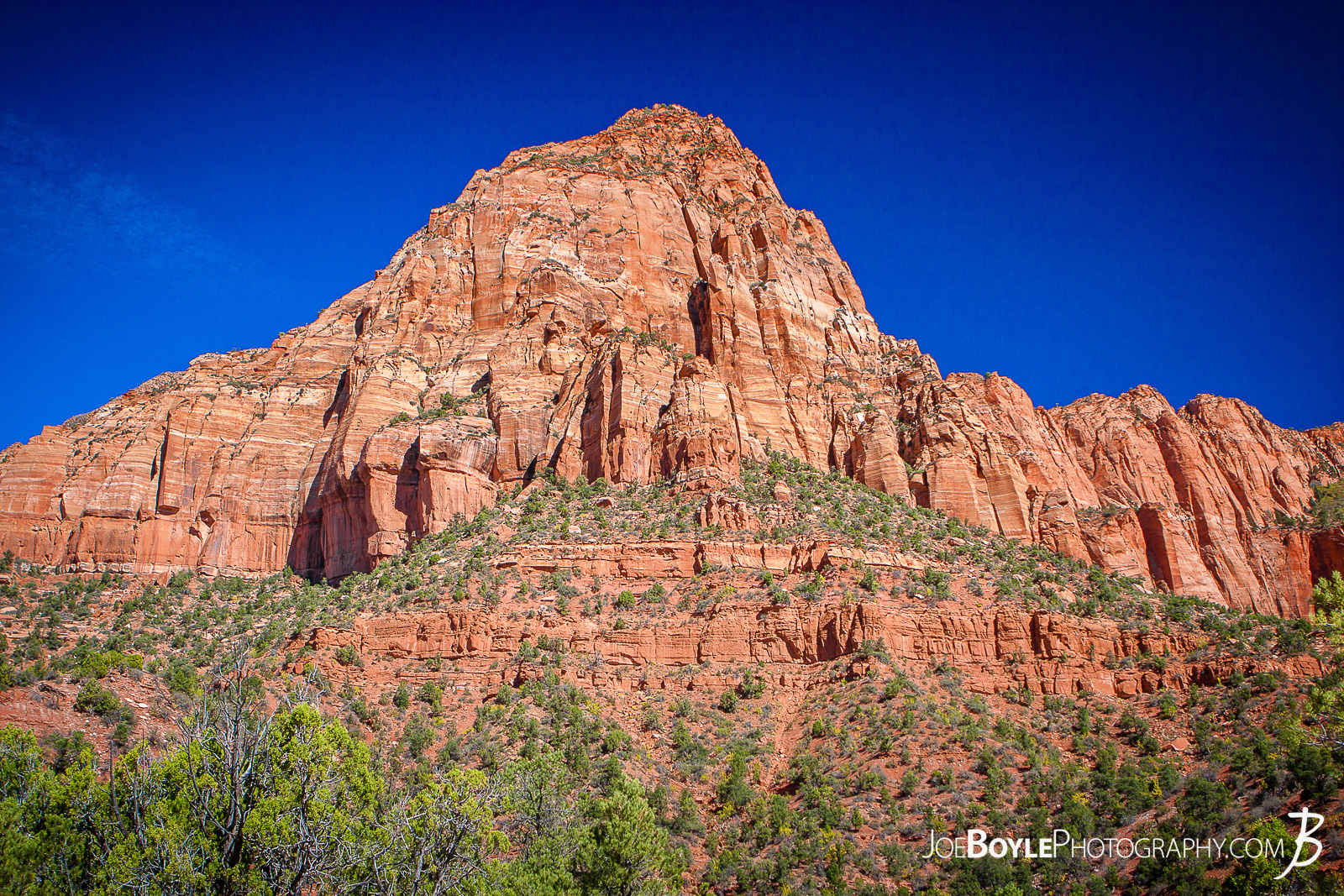  This is a photo near the start of the trailhead for the Kolob Canyon Trail in Zion National Park. The trail was a beautiful and pleasant 14 mile round trip. My hiking buddy Caleb and I hiked it together and saw the Koleb Arch near the half way point. Interestingly, I noticed the terrain changed quite a bit as we descened. It started off as I expected,... rocky. Their were large sections, however that were quite sandy. That slowed us down a little bit, but not too much. I just didn't expect it! Here are some links to more articles and and hiking info about the Koleb Canyon Trail, Koleb Arch, other hiking trails in Zion National Park and a Map of Zion National Park. 