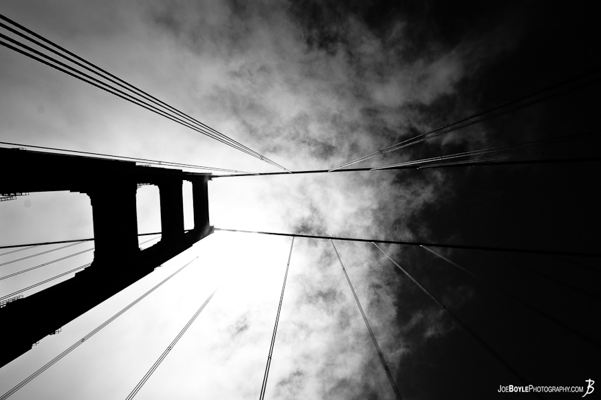 A photo of one of the Golden Gate Bridge towers and cables against the sky. A photo of one of the Golden Gate Bridge towers and cables against the sky.