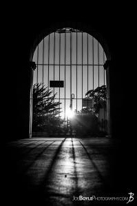 gate-at-carmel-mission-basilica-black-white